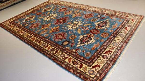 "Handcrafted Afghani carpet with intricate designs and vibrant colors."