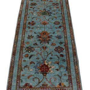 Afghan handwoven floral rug showcasing intricate designs on a blue background